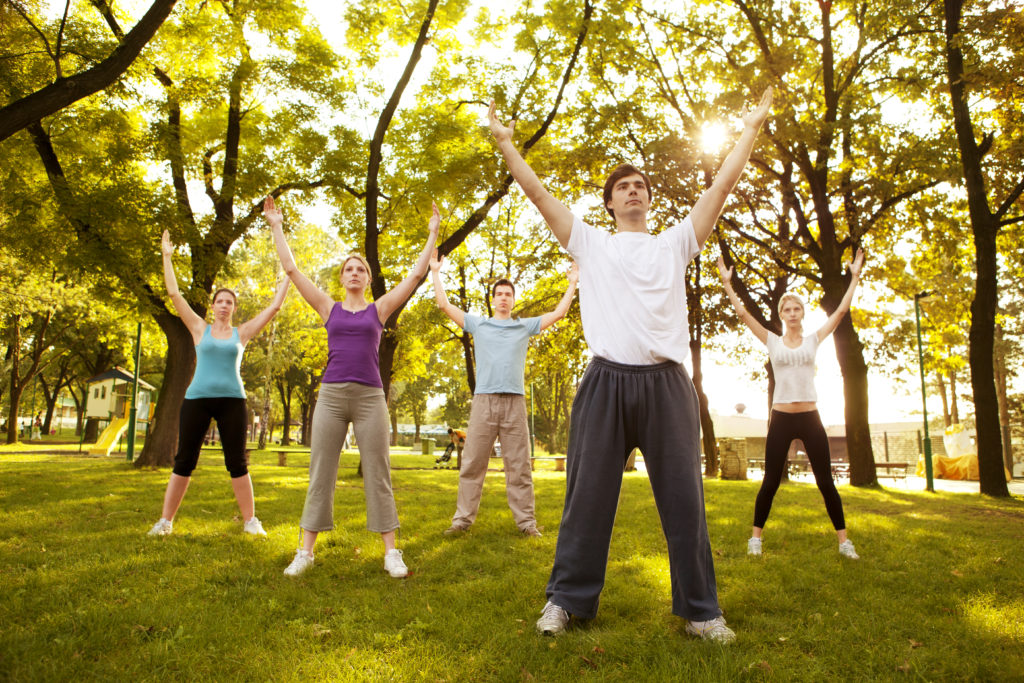 people practicing tai chi in the park